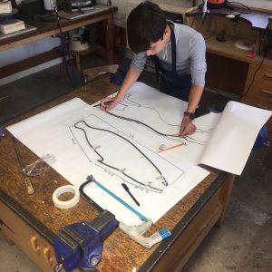 boy creating a metal frame